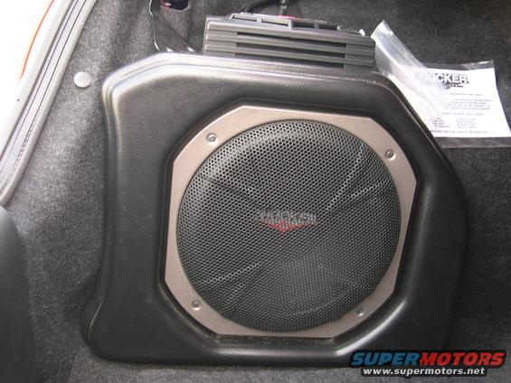Kicker subwoofer in custom enclosure with installation manual in plastic bag