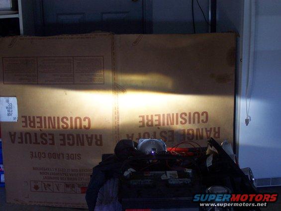 Headlight beam on cardboard box with French text