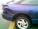 1996 Ford Probe - Rear view of a blue 1996 Ford Probe showing extensive damage to the rear quarter panel and bumper.