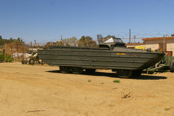 Green amphibious military vehicle with USMC 238624 text on side