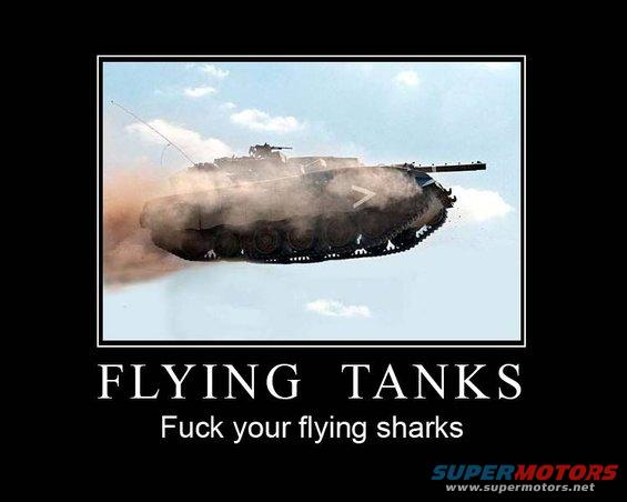 Tank airborne, kicking up dust, against a cloudy sky