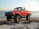 1978 Ford Bronco - This lifted 1978 Ford Bronco is parked on a beach with the ocean in the background.