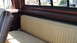 1979 Ford F-350 - The interior of a truck shows a tan bench seat with brown trim and a view out the window.