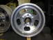 1987 Ford Bronco - A silver aluminum wheel with a chrome center cap is shown in a close-up view.