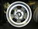 1987 Ford Bronco - Close-up of an aluminum wheel with five oval cutouts and a chrome center cap.