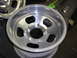 1987 Ford Bronco - A close-up view of an aluminum wheel, showing the lug nut pattern and rim detail.