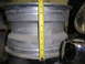 1987 Ford Bronco - A close-up view of a wheel rim with a yellow tape measure indicating its size.