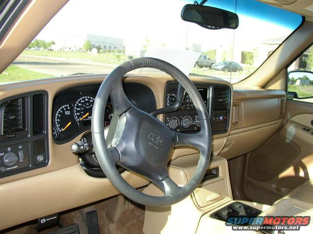Dashboard and steering wheel of a Chevrolet truck. Gauges and center console visible