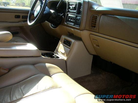 Tan leather seats and dashboard of a truck interior, showing center console and steering wheel