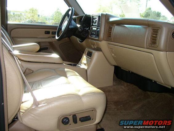 Tan leather seats and dashboard of a truck. Power seat controls visible