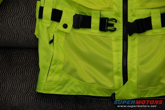 Close-up of a bright yellow motorcycle jacket with black buckles and mesh pockets