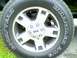 2002 Ford Crown Victoria - Close-up of a Goodyear Wrangler AT/S tire and a silver 5-spoke wheel with Ford branding.