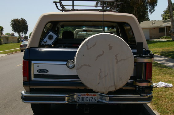 Rear view of a Ford Bronco with a spare tire cover and a roof rack