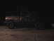 1980 Dodge Magnum - Side view of a pickup truck with large tires, likely from the 1970s.