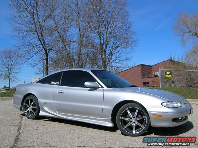 Silver 1994 Mazda MX-6 coupe with custom wheels and body kit