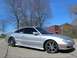 1994 Mazda MX-6 - A silver 1994 Mazda MX-6 coupe is shown from a three-quarter front angle, aftermarket wheels and a lowered stance.