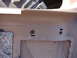 1996 Ford Bronco - Close-up view of a vehicle's interior door panel, showing mounting hardware and insulation.