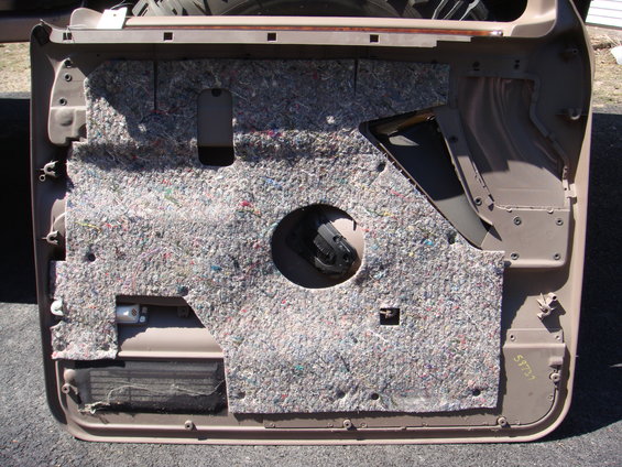 Tan car door panel with insulation and speaker hole. Part number 59737 visible