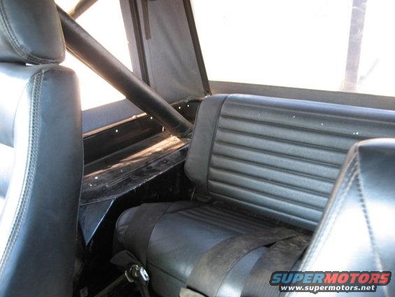 Black vinyl seats and roll cage inside a vehicle