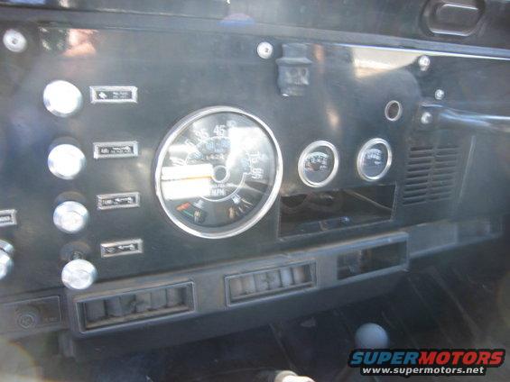 Jeep CJ dashboard with round speedometer and auxiliary gauges