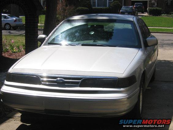 Silver sedan with a chrome grille and dark headlights, parked outdoors