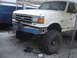 1989 Ford Bronco - This lifted Ford Bronco has a custom winch mount and is covered in dirt.