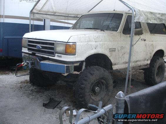 1989 Ford Bronco with large off-road tires and a front winch bumper