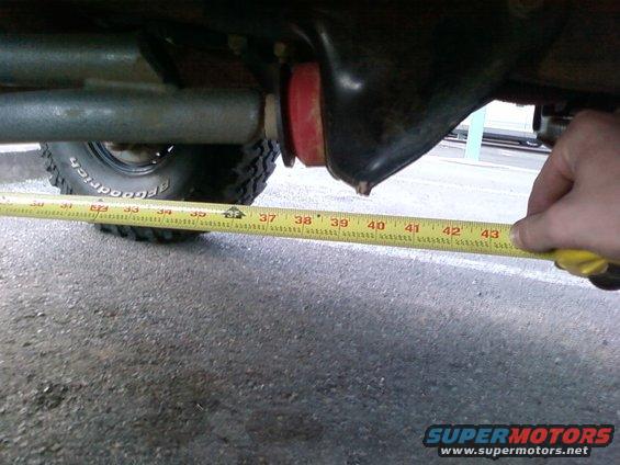 Undercarriage of a vehicle with a measuring tape showing approximately 43 inches