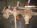 1979 Ford Bronco - Front axle assembly, likely from a 4x4 vehicle, is shown with its shock absorber and brake components.