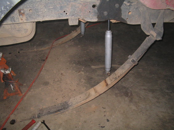 close-up of leaf springs and shock absorbers on a vehicle frame