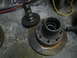 1979 Ford Bronco - Wheel hub and brake rotor components are shown on a concrete floor.