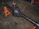 1979 Ford Bronco - A black differential axle is supported by orange jack stands on a concrete floor.