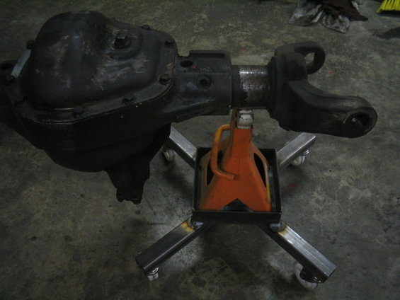 Vehicle axle assembly on a metal stand with casters