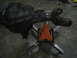 1979 Ford Bronco - A vehicle axle assembly is supported by a custom metal stand with an orange jack.
