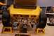 1996 Ford Bronco - Custom yellow hot rod displayed with its trunk open and wide tires on display stands.