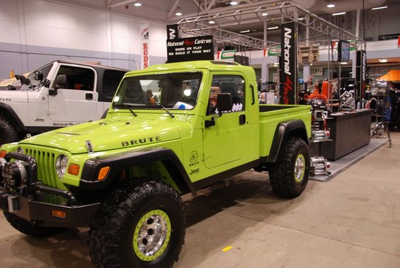 Lime green Jeep Brute pickup truck with custom wheels and off-road tires