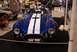 1996 Ford Bronco - Blue and white AC Cobra replica on display at an indoor event with other vehicles present.