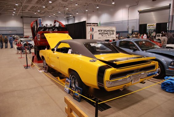 Yellow 1970 Dodge Charger rear view with black racing stripes