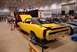 1996 Ford Bronco - A yellow 1970 Dodge Charger is displayed at a car show, with a blue Ford Mustang parked nearby.