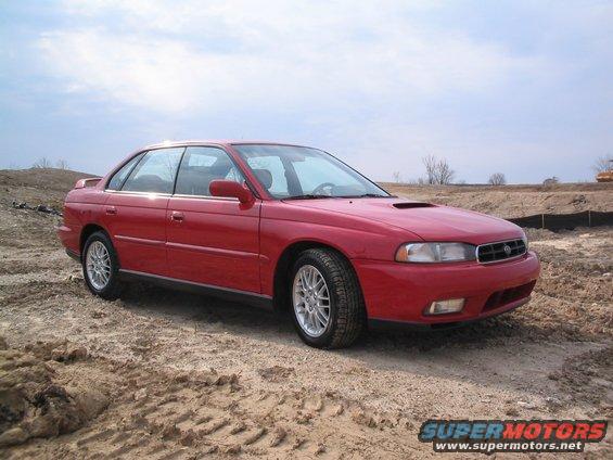 1997 Subaru Legacy sedan parked on a dirt lot