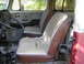 1971 Volkswagen Vanagon - Interior of a van showing the front seats and dashboard. The upholstery is worn and torn.