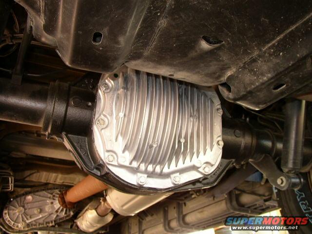 Underside view of a vehicle's rear differential and transfer case with exhaust system visible