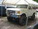 1989 Ford Bronco - This lifted 1989 Ford Bronco is parked under a canopy.