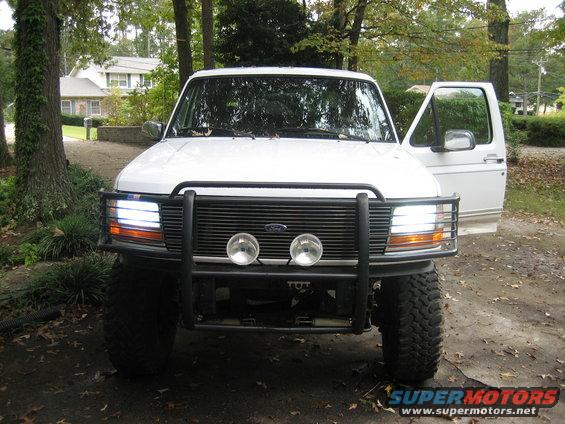 1996 Ford Bronco front view, driver's door open, bull bar, off-road tires