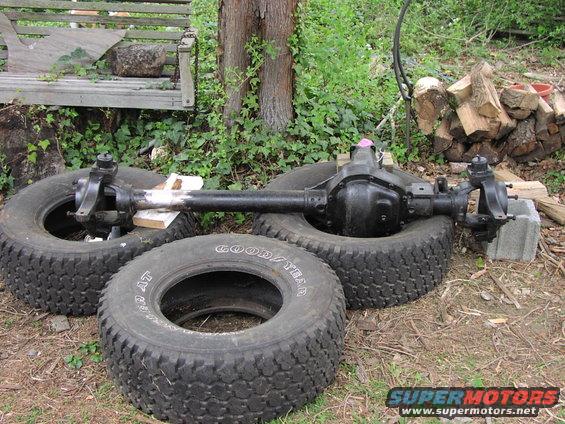 Front axle assembly on tires with Goodyear branding visible