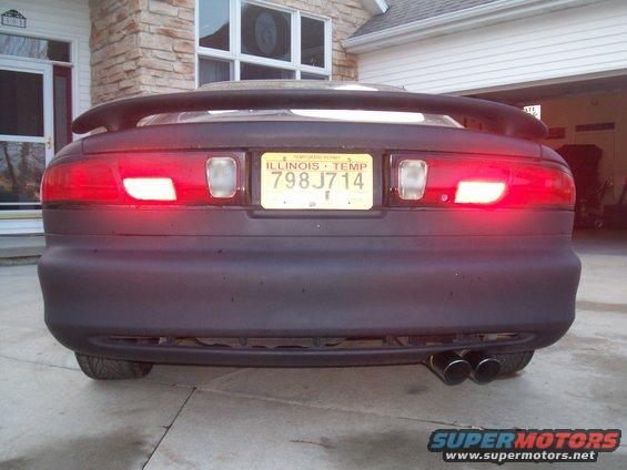 Dark matte 1993 Ford Probe rear view with spoiler and dual exhaust