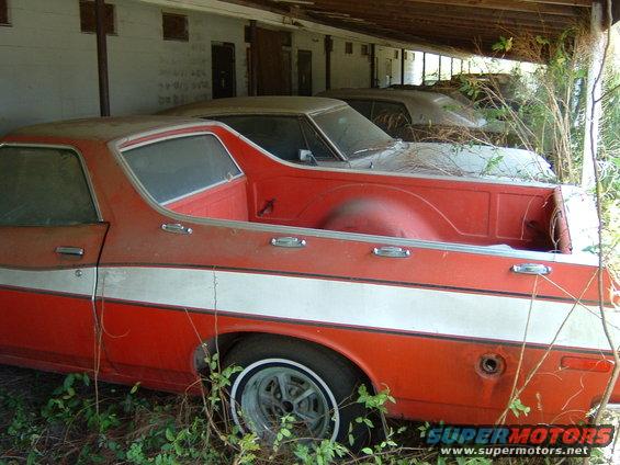 Side view of a red and white 1979 Ford Ranchero with a white stripe