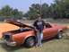 1979 Ford Ranchero - Orange 1977 Ford Ranchero with hood open, parked on grass with a man standing beside it.