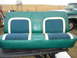 1979 Ford F-150 - A green bench seat with blue fabric inserts and white trim is shown outdoors with a green truck in the background.