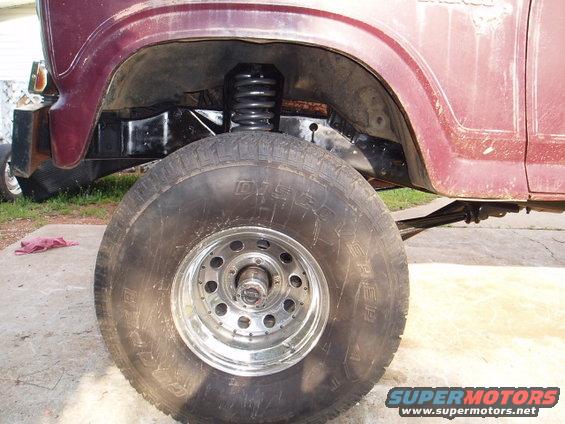 1980 Ford Bronco front wheel, suspension, and fender well detail. Maroon paint